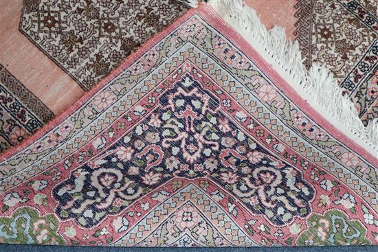 A Persian pattern rose ground cotton and silk rug 298 x 215cm